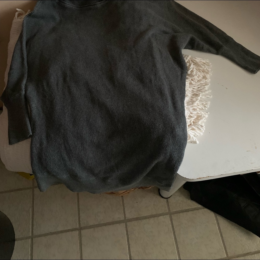 Mid arm length sweater wears a bit longer in the back.